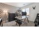 Stylish home office with a large desk and geometric wallpaper at 10009 Cabernet Hills St, Las Vegas, NV 89141