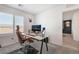 Bright home office with a desk, two monitors, and built-in shelves at 10009 Cabernet Hills St, Las Vegas, NV 89141