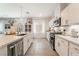 Modern kitchen with white cabinets, stainless steel appliances, and large island at 10009 Cabernet Hills St, Las Vegas, NV 89141