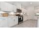 Modern kitchen with white cabinets, stainless steel appliances, and ample counter space at 10009 Cabernet Hills St, Las Vegas, NV 89141