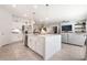 Open concept kitchen with large island, white cabinets, and stainless steel appliances at 10009 Cabernet Hills St, Las Vegas, NV 89141