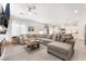 Spacious living room featuring a large sectional sofa, fireplace, and plenty of natural light at 10009 Cabernet Hills St, Las Vegas, NV 89141