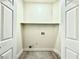 Laundry closet with shelving and hookups for washer and dryer at 10030 Mystic Moss St, Las Vegas, NV 89183