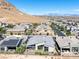 Aerial view of a modern home with a backyard and solar panels, situated in a community with mountain views at 10271 Meridian Hill Ave, Las Vegas, NV 89135