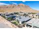 Aerial view showcasing a contemporary home with a private backyard in a new development against mountain backdrop at 10271 Meridian Hill Ave, Las Vegas, NV 89135