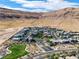 Aerial view of the community, showing homes, a park, and mountains in the background at 10271 Meridian Hill Ave, Las Vegas, NV 89135