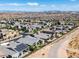 Aerial view of a community with modern houses, showcasing a home with a private backyard and solar panels at 10271 Meridian Hill Ave, Las Vegas, NV 89135