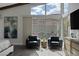 Main bedroom with seating area, large window, and mountain views at 10271 Meridian Hill Ave, Las Vegas, NV 89135