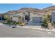 Modern house exterior with attached garage and desert landscaping at 10271 Meridian Hill Ave, Las Vegas, NV 89135