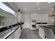 Modern kitchen with white cabinets, granite counters, and stainless steel appliances at 10271 Meridian Hill Ave, Las Vegas, NV 89135