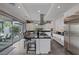 Modern kitchen with island, stainless steel appliances, and view to backyard at 10271 Meridian Hill Ave, Las Vegas, NV 89135