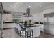 Modern kitchen with island, stainless steel appliances, and view to backyard at 10271 Meridian Hill Ave, Las Vegas, NV 89135