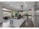 Modern kitchen with island, stainless steel appliances, and view to backyard at 10271 Meridian Hill Ave, Las Vegas, NV 89135