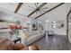 Open living room with hardwood floors, exposed beams, and a view into the kitchen at 10271 Meridian Hill Ave, Las Vegas, NV 89135