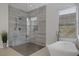 Large walk-in shower with gray tile and built-in seat at 10271 Meridian Hill Ave, Las Vegas, NV 89135