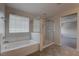 Bathroom with glass shower, garden tub and window at 10273 Aragon Crown Rd, Las Vegas, NV 89135
