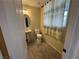 Cozy half-bathroom featuring tile flooring, a pedestal sink, and a decorative shower curtain at 10273 Aragon Crown Rd, Las Vegas, NV 89135