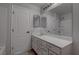 Bathroom with marble countertop vanity, large mirror and white cabinets at 10273 Aragon Crown Rd, Las Vegas, NV 89135