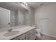 Bathroom with marble countertop vanity, large mirror and white cabinets at 10273 Aragon Crown Rd, Las Vegas, NV 89135