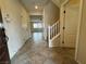 Welcoming entryway featuring tile flooring, a staircase, and convenient access to the living spaces at 10273 Aragon Crown Rd, Las Vegas, NV 89135