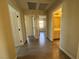 Hallway with wood-look floors and access to bedrooms and bathroom at 10273 Aragon Crown Rd, Las Vegas, NV 89135