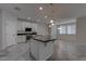 Stylish kitchen with a large island, pendant lighting, and sleek black countertops at 10273 Aragon Crown Rd, Las Vegas, NV 89135