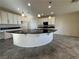 Large kitchen island with dark countertop and white cabinets at 10273 Aragon Crown Rd, Las Vegas, NV 89135