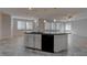 Kitchen island with black countertops, a sink, and modern appliances at 10273 Aragon Crown Rd, Las Vegas, NV 89135