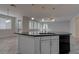 Open kitchen island with a black countertop and modern pendant lighting at 10273 Aragon Crown Rd, Las Vegas, NV 89135