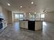 Kitchen showcasing a large island, modern appliances, and seamless flow to the living area at 10273 Aragon Crown Rd, Las Vegas, NV 89135