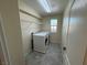 Laundry room with washer, dryer, and shelving at 10273 Aragon Crown Rd, Las Vegas, NV 89135