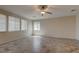 Expansive living room featuring tile flooring, ample natural light, and a modern ceiling fan at 10273 Aragon Crown Rd, Las Vegas, NV 89135