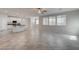 Open-concept living space with tile floors, modern lighting, and a kitchen with white cabinetry at 10273 Aragon Crown Rd, Las Vegas, NV 89135