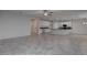 Spacious living area featuring tile flooring, a modern kitchen, and ample room for entertaining at 10273 Aragon Crown Rd, Las Vegas, NV 89135