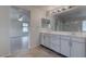 Elegant bathroom with double sink vanity, large mirror, and tile flooring at 10273 Aragon Crown Rd, Las Vegas, NV 89135