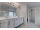 Main bathroom with double sink vanity, large mirror, and walk-in shower at 10273 Aragon Crown Rd, Las Vegas, NV 89135