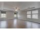 Spacious main bedroom with tray ceiling, ceiling fan, and bright, light filled windows at 10273 Aragon Crown Rd, Las Vegas, NV 89135