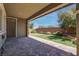 Covered patio with a brick paver floor, artificial turf, and well-manicured landscaping at 10273 Aragon Crown Rd, Las Vegas, NV 89135