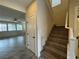 Staircase with wood steps and white railing, leading to the upper level of the home at 10273 Aragon Crown Rd, Las Vegas, NV 89135