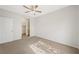 This bedroom features neutral walls, carpet floors, closet, a ceiling fan, and an entry door at 10280 Gilmore Canyon Ct # 203, Las Vegas, NV 89129