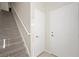 Bright entryway featuring tiled floors, staircase, and white doors for a clean, modern look at 10280 Gilmore Canyon Ct # 203, Las Vegas, NV 89129