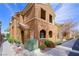 Warm-toned townhouse with arched entryways and well-maintained landscaping, offering curb appeal at 10280 Gilmore Canyon Ct # 203, Las Vegas, NV 89129