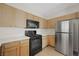 Functional kitchen with stainless steel refrigerator, gas range, and wooden cabinetry at 10280 Gilmore Canyon Ct # 203, Las Vegas, NV 89129