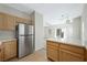 Modern kitchen featuring stainless steel refrigerator, sleek countertops and wood cabinets at 10280 Gilmore Canyon Ct # 203, Las Vegas, NV 89129