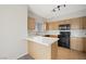 Modern kitchen with white countertops, wooden cabinets, and stainless steel appliances at 10280 Gilmore Canyon Ct # 203, Las Vegas, NV 89129