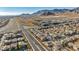 An aerial view of a residential neighborhood nestled in a mountainous region at 10611 Auburn Springs Ave, Las Vegas, NV 89166