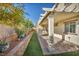 Landscaped backyard with stone wall, artificial turf, and plants at 10611 Auburn Springs Ave, Las Vegas, NV 89166