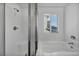 Bathroom with shower, tub, and window at 10611 Auburn Springs Ave, Las Vegas, NV 89166