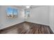 Well-lit bedroom featuring wood-look floors and large windows at 10611 Auburn Springs Ave, Las Vegas, NV 89166