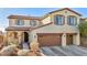 Two story home with a two car garage and landscaped yard at 10611 Auburn Springs Ave, Las Vegas, NV 89166